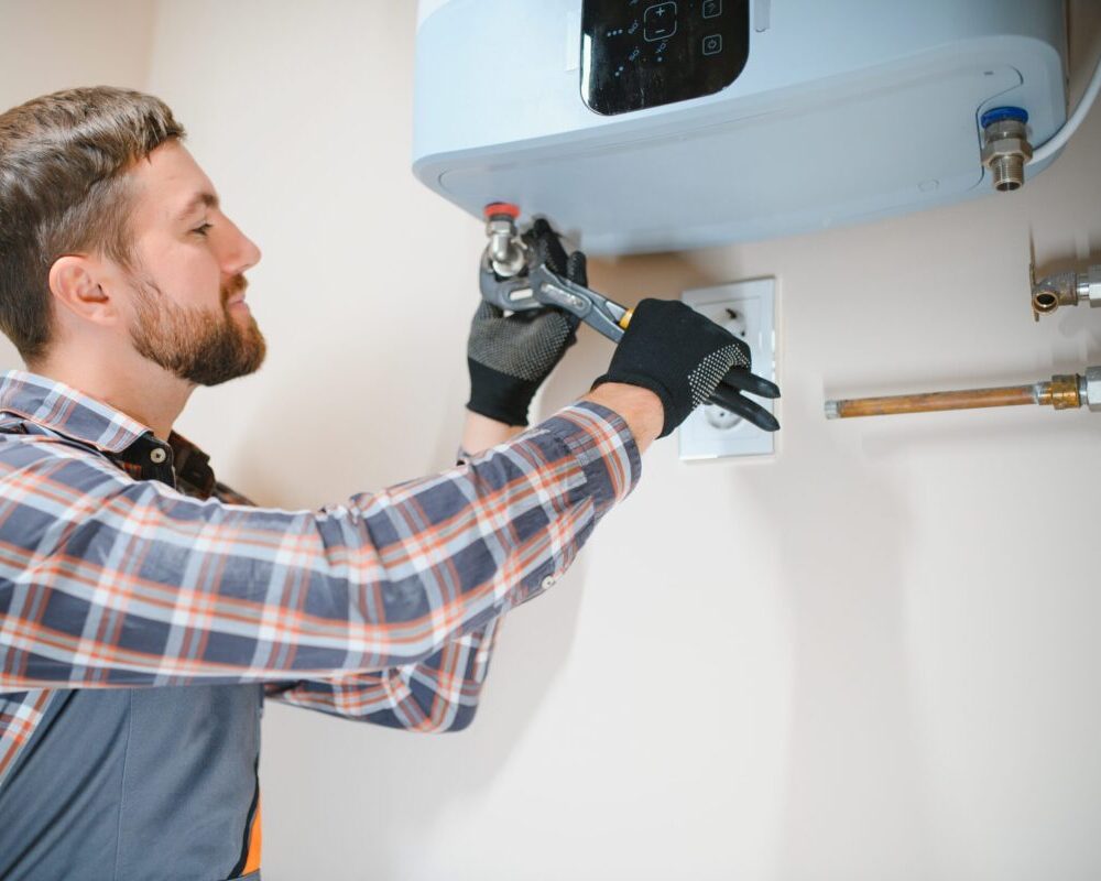 Professional engineer installing a natural gas boiler at home, he is checking the pipes.